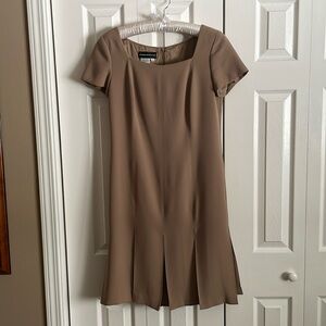 Square neck, fully lined, box pleated front and back.